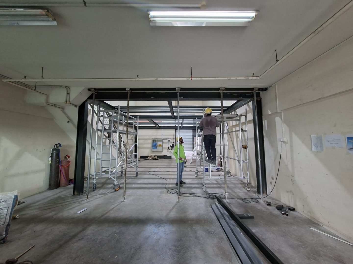 Long view down the Frontier Industrial Building unit showing the mezzanine framing aligned along the side wall during installation